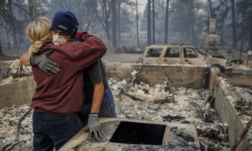 Michael John Ramirez hugs his wife Charlie Ramirez after they manage to recover her keepsake bracelet that didn’t melt in the fire.