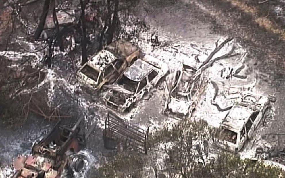 Burned out buildings and vehicles are seen on a scorched landscape in the Deepwater area of Queensland