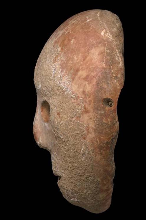 The side view of the ancient mask shows one of four holes, possibly to allow the mask to be worn in rituals.