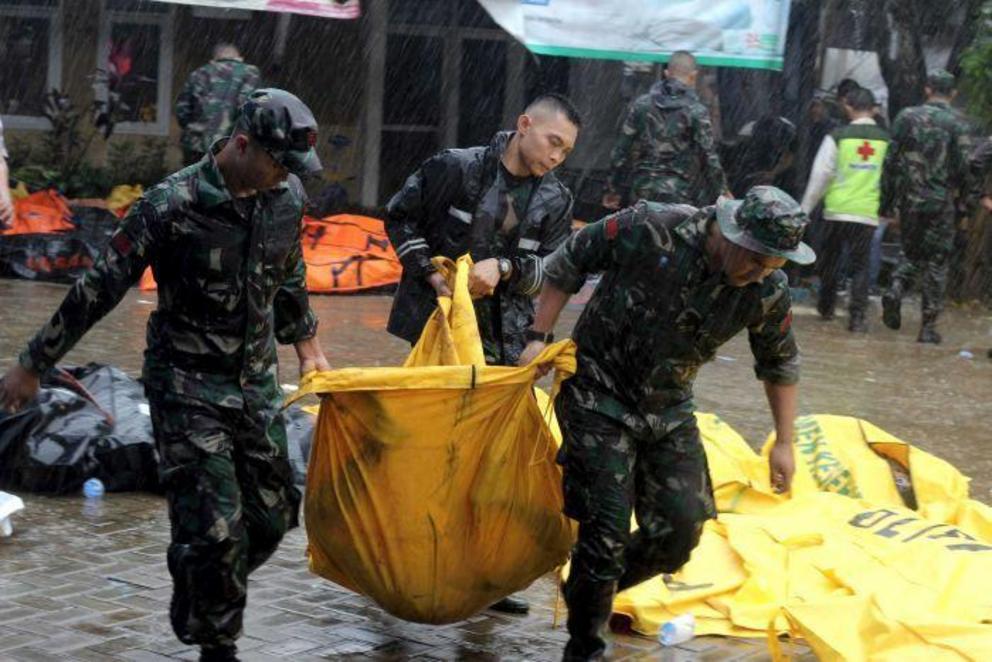 Indonesian authorities are battling debris and difficult weather to search for bodies.