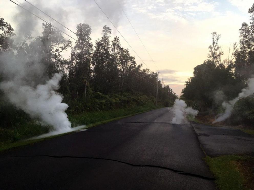 A fissure produces steam from a street after the eruption of Hawaii’s Kilauea volcano Friday.