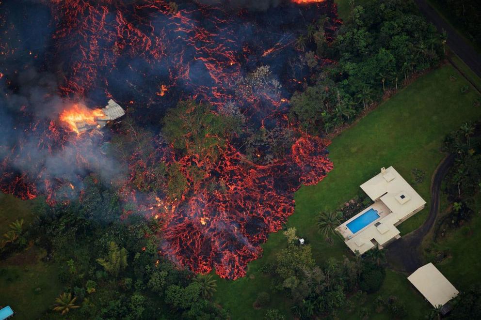 Lava from a robust fissure eruption on Kilauea’s east rift zone consumes a home, then threatens another, near Pahoa, Hawaii, on May 6, 2018. 