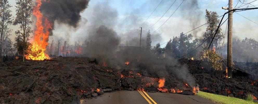 Lava from a fissure slowly advances to the northeast on Hookapu Street after the eruption of Hawaii’s Kilauea volcano on Saturday in the Leilani Estates subdivision near Pahoa, Hawaii.