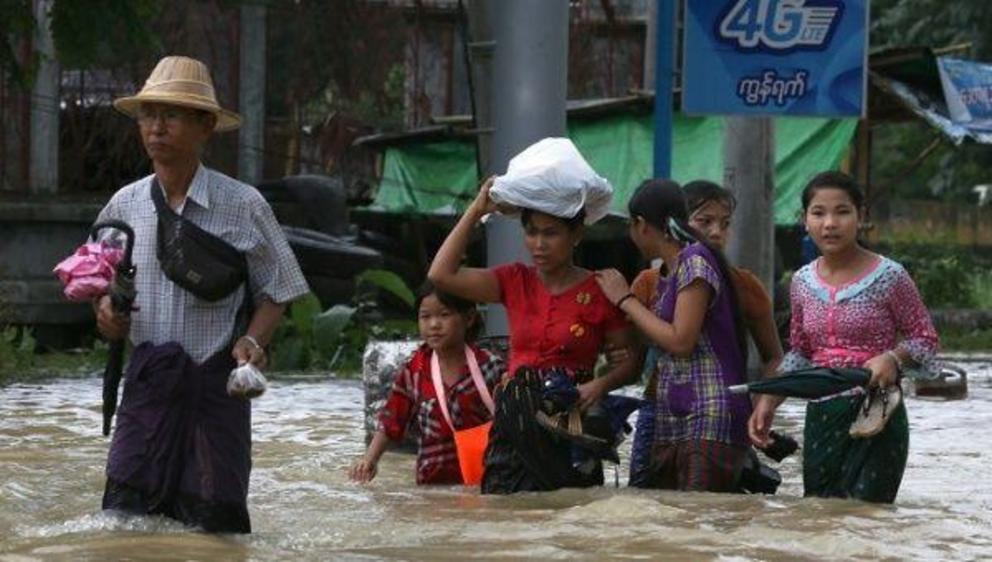 People wade through a flooded street in Bago, Myanmar, July 27, 2018. Picture taken July 27, 2018. | Photo: Reuters