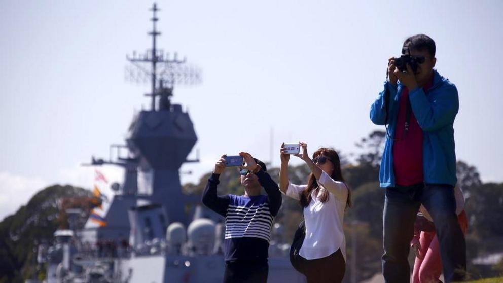 Chinese tourists in front of an Australian naval ship, Sydney, Australia © David Gray / Reuters