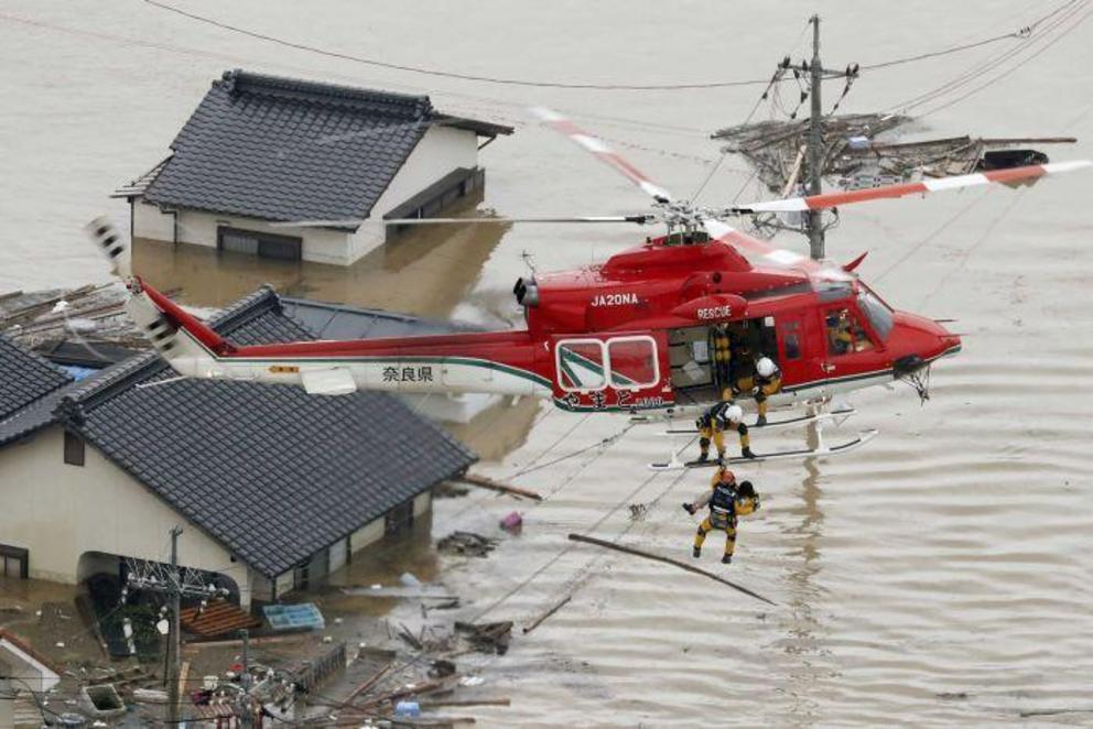 A resident is rescued from a submerged house in Kurashiki. 