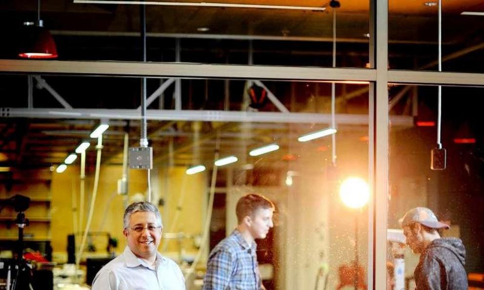 Northeastern professor Taskin Padir, far left, found that seafood processing plants in New Bedford were enthusiastic about bringing in robots.