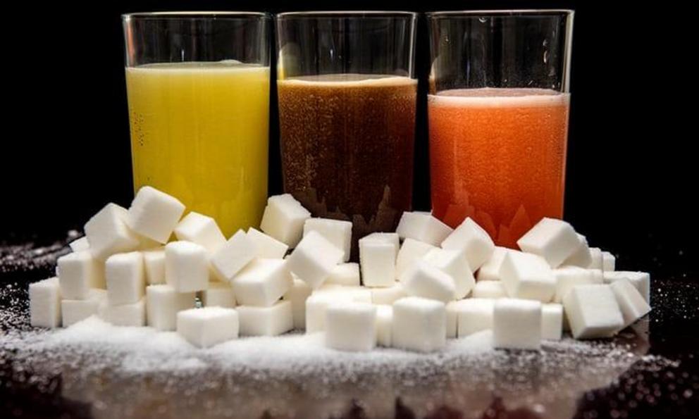 Carbonated drinks with their sugar content represented by sugar cubes. Food manufacturers have been urged to cut the sugar in their products by 20% by 2020.
