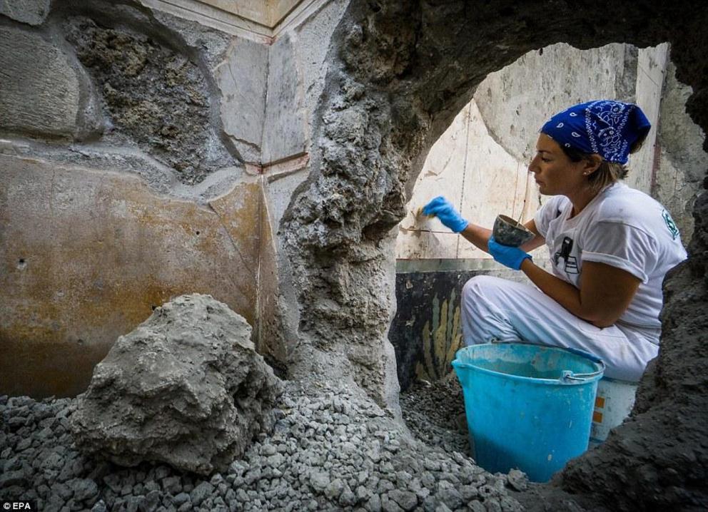 During the conservation work, new finds were uncovered at a private house called the 'House of Jupiter' (Casa di Giove) the Regio V part of the ancient city. Pictured is an archaeologist during excavations at the site