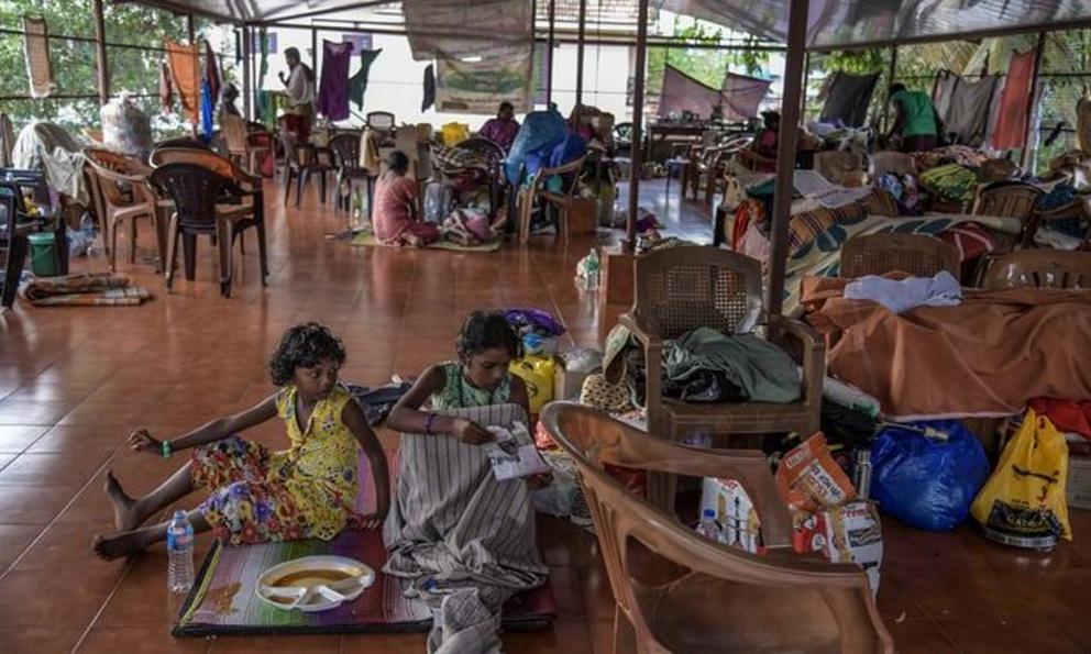 Villagers take shelter at a relief camp in a college in Chengannur, Kerala 