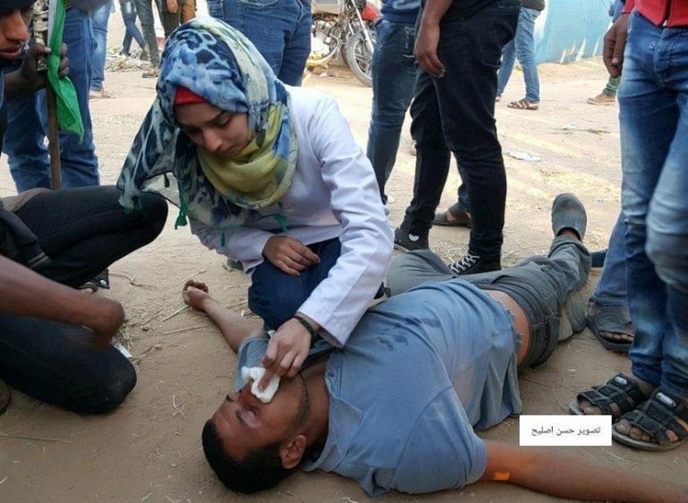 Featured image: Razan al-Najjar, the 21 year old Gaza medic killed by an Israeli sniper on June 1, treating an injured man, undated photo from Palestine Live on twitter.
