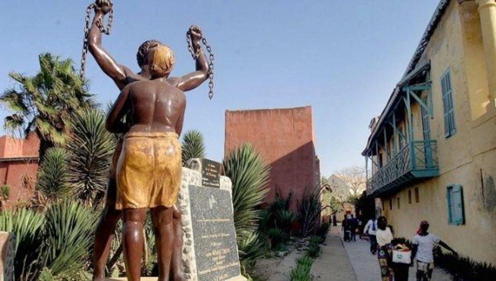 Senegalese women walk past a monument to slavery near the Slave house on Goree island 3km off Dakar, Senegal . | Photo: EFE