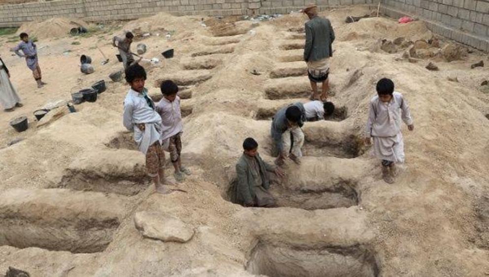 Boys inspect graves prepared for victims of Thursday's air strike in Saada province, Yemen. | Photo: Reuters