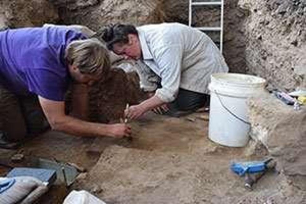 Nathaniel Kitchel (left), a former UW doctoral student in anthropology, and Maureen Boyle, an archaeologist from Utah State University, excavate an ephemeral fire hearth in a cave site in the Bighorn Mountains in 2017. Data collected at this site were use