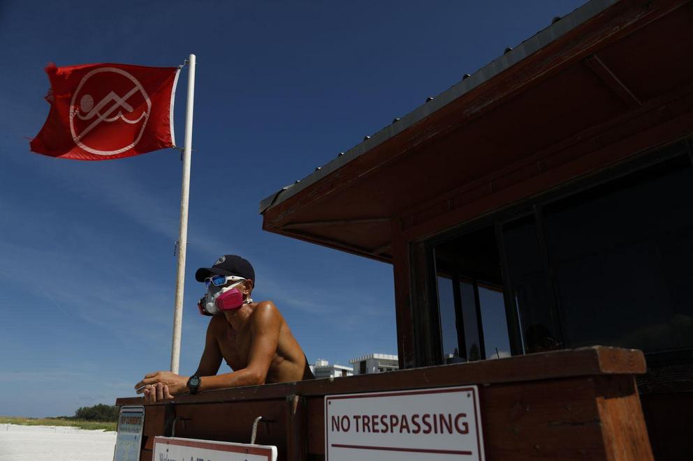  Sarasota County Emergency Services lifeguard Mariano Martinez wears a mask Aug. 26 because of red tide at Lido Beach in Sarasota, Fla. 