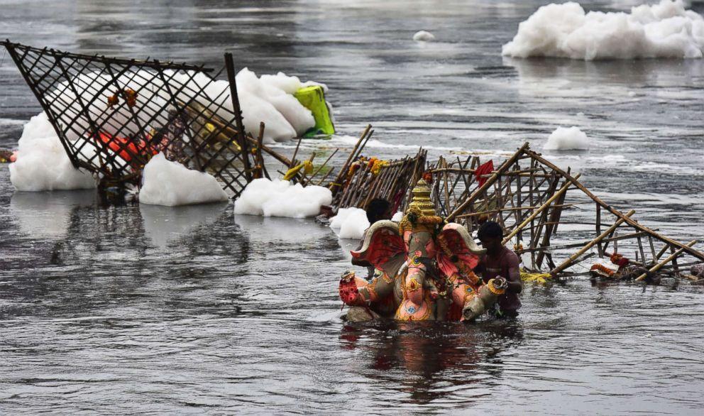 A Ganesh idol is seen on the banks of the polluted Yamuna river, Sept. 24, 2018, in Noida, India. Lord Ganesh is considered the remover of obstacles and the idols are immersed on the last day of the Ganesh Chaturthi festival. 