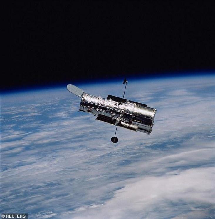 The Hubble Space Telescope (HST) is seen in this March 9, 2002 NASA file photo with the Earth as a backdrop.