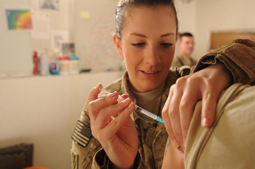 An airman administers a vaccine to an Army cavalry scout at Fort Stewart, Ga., April 25, 2013. (Staff Sgt. Patrice Clarke/Air Force)