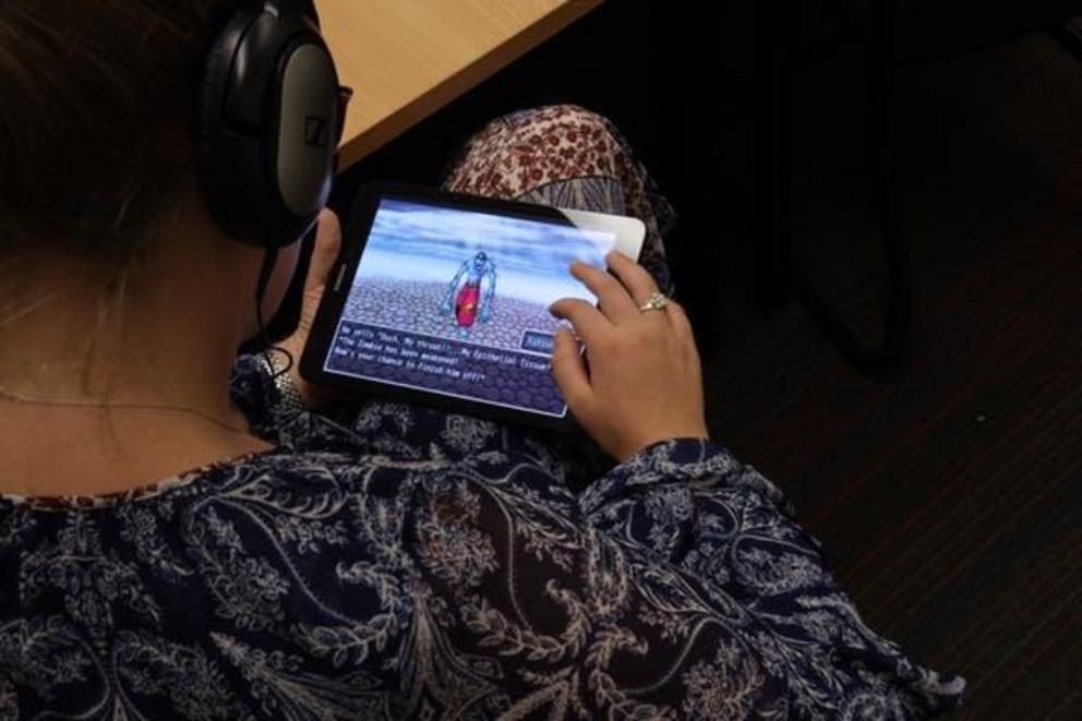 A student uses a tablet during a science lesson to play a game that assesses their understanding of the content covered. 