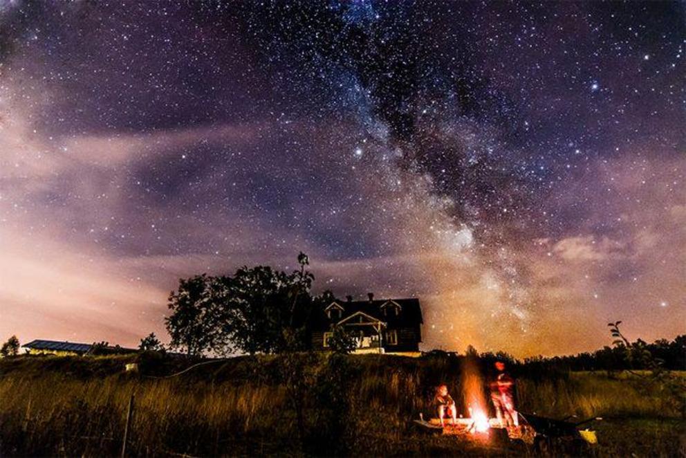An evening by a campfire under the Milky Way as captured in Lapino Kartuskie, Pomeranian, Poland.