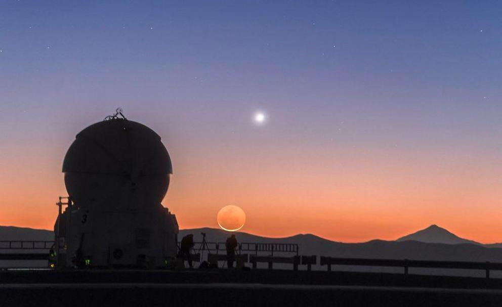 Venus gives way to the rise of a crescent moon at sunrise, as captured at the European Southern Observatory.