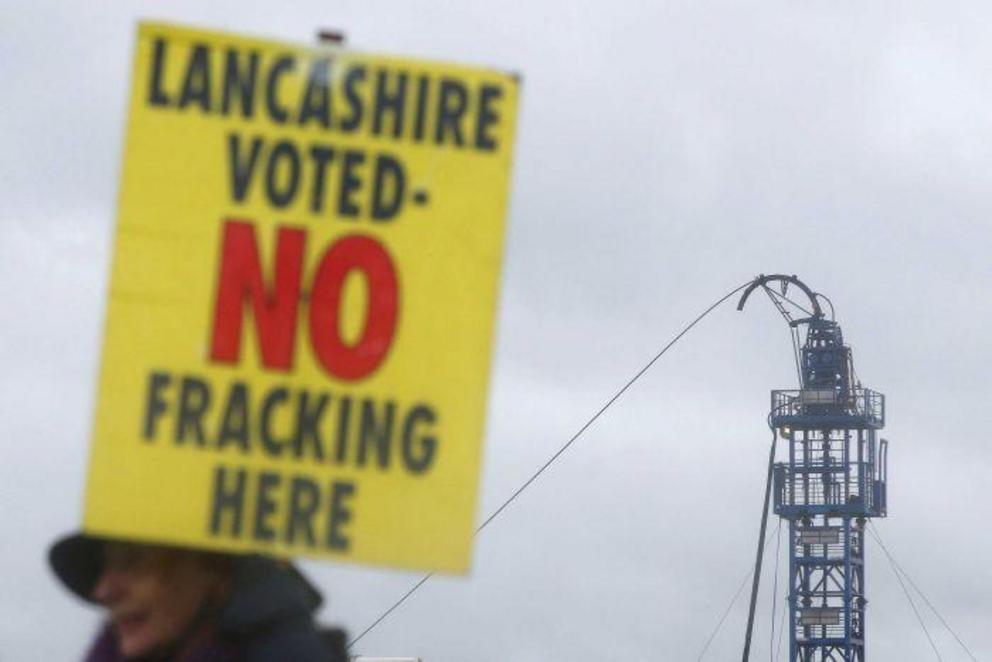 Photo: A protester stands outside Cuadrilla's Preston New Road fracking site near Blackpool. (Reuters: Andrew Yates) 