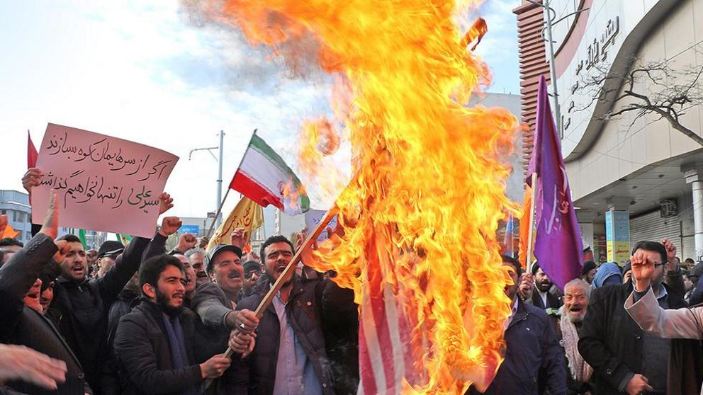Iranian men burn a US flag during a protest in support of the Islamic republic's government and supreme leader, Ayatollah Ali Khamenei, in the northwestern city of Ardabil on November 20, 2019 © AFP 