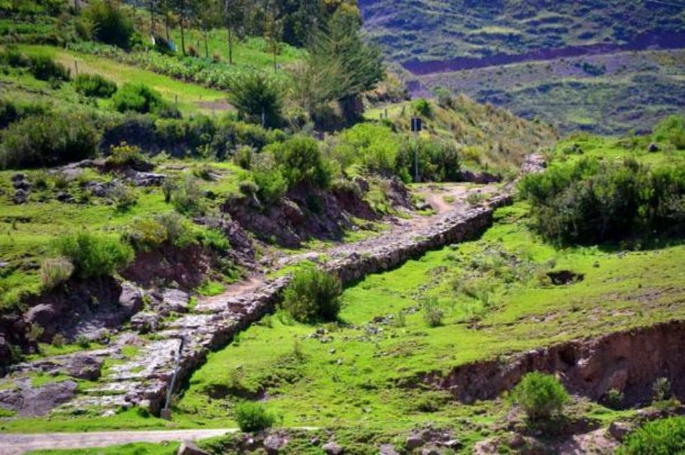 A road from the Inca Empire climbing a hillside at the Mosollaqta Lake, Peru.