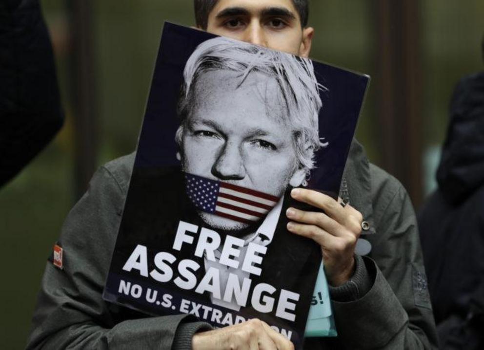        A supporter of WikiLeaks founder Julian Assange demonstrates in London earlier this year. (Kirsty Wigglesworth / AP) 