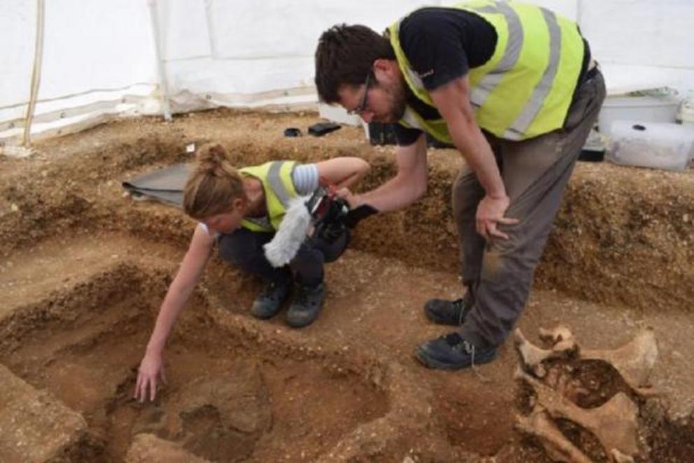 Archaeologists unearthing the warrior shield together with the remains of the man