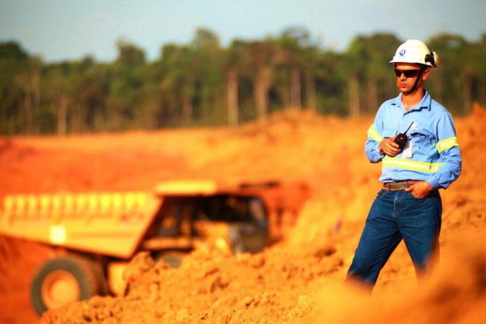 An industrial mining operation in Brazil. Note the forest at the edge of the open pit mine.