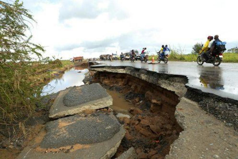 Motorcycles pass through a section of road damaged by Cyclone Idai in Nyamatanda, about 50 kilometres from Beira, in Mozambique.