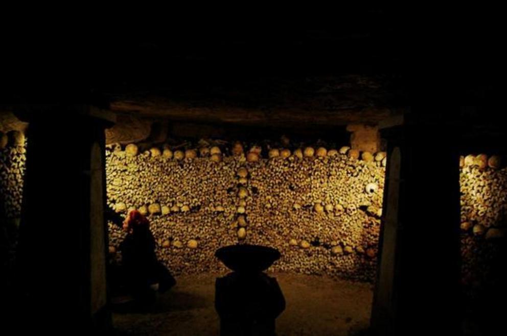 The living and the dead both inhabit the Paris Catacombs.