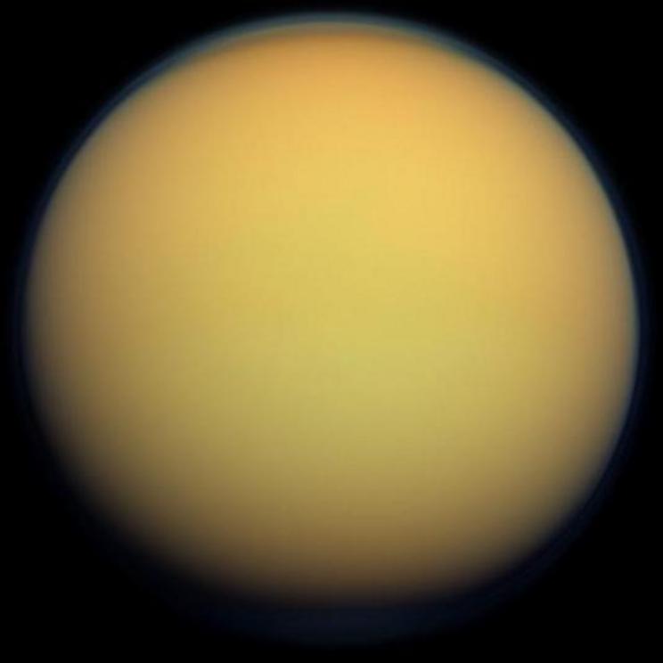 This true-color image of Titan, taken by the Cassini spacecraft, shows the moon’s thick, hazy atmosphere.
