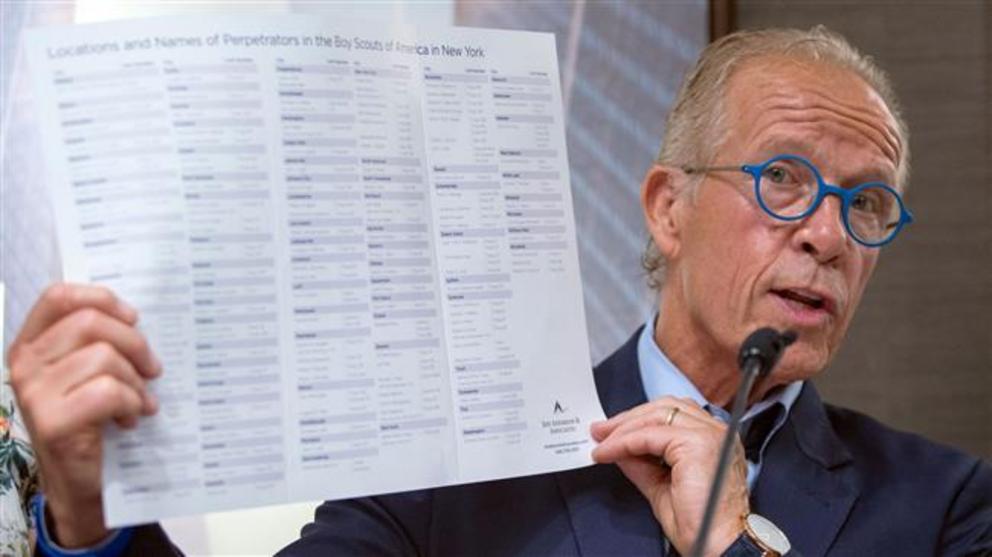 Attorney Jeff Anderson shows a brochure with names as he speaks to media during a press conference about New York Boy Scout leaders accused of sexual abuse on April 23, 2019 in Manhattan, New York.