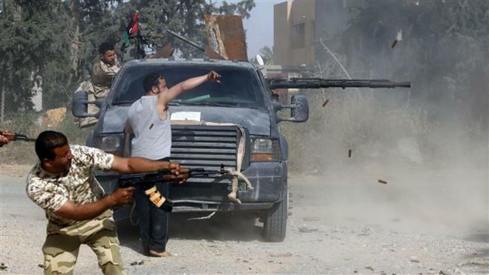 Libyan forces loyal to the Government of National Accord (GNA) fire their guns during clashes with fighters loyal to strongman Khalifa Haftar south of the capital Tripoli on April 20, 2019. (Photo by AFP)