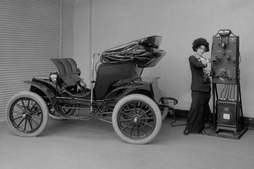 Photo: It's a far cry from the Tesla, but this woman is charging an early electric car. (Getty: Corbis/Hall of Electrical History Foundation) 