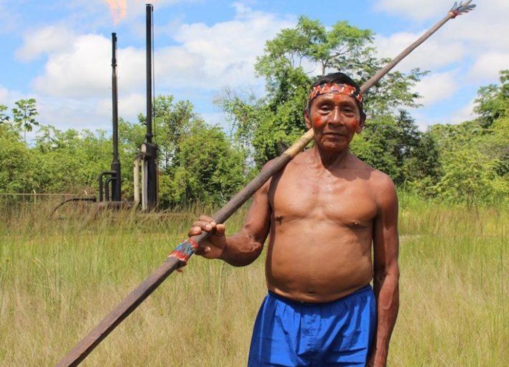 A Waorani man visits an oil development site in Ecuador’s Pacayacy parish as part of the “Toxic Tour” put on by an NGO in 2018. Some Waorani attending the tour were shocked by the waste pools and flares they encountered. “We have clean air, clean water,” 