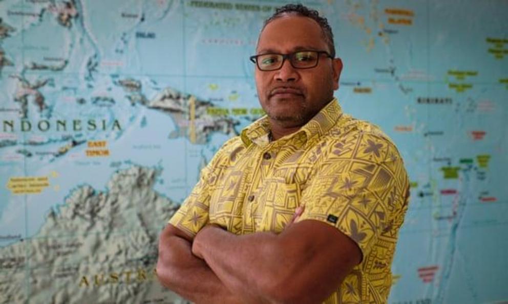 Tevita Tupou, from the Oceania Customs Organisation, in front of a Pacific region map.