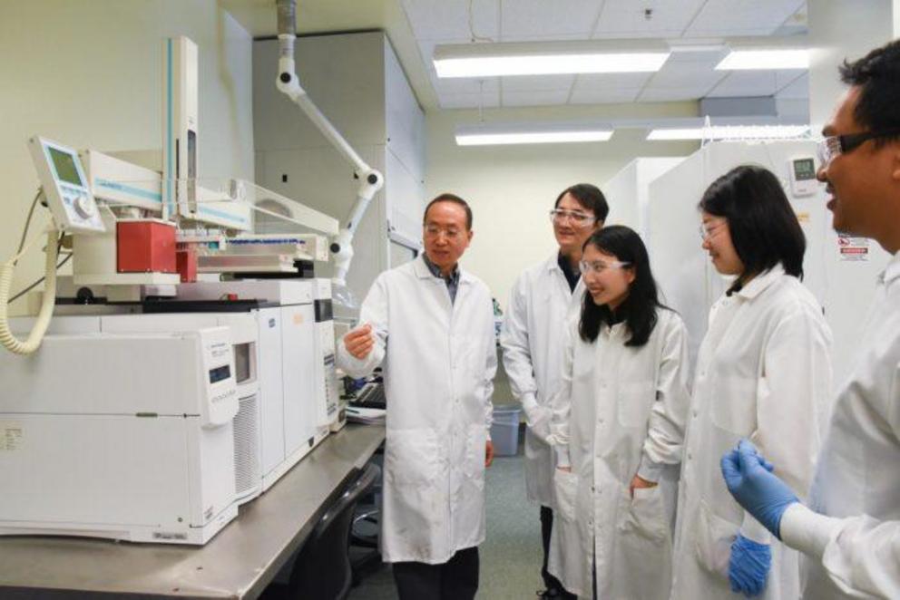 Dr. Hanwu Lei and his research team in the lab, working to find a use for plastic waste.