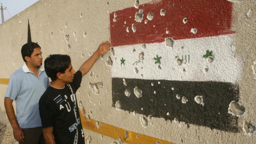 FILE PHOTO. An Iraqi flag painted on a bullet-ridden wall of a maternity hospital after an air strike by the US military in Baghdad's Sadr City. ©REUTERS / Kareem Raheem 