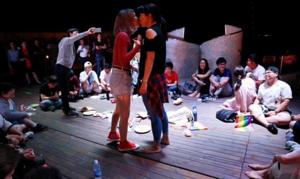 Chinese women kiss on a cruise organised by PFLAG in 2017.