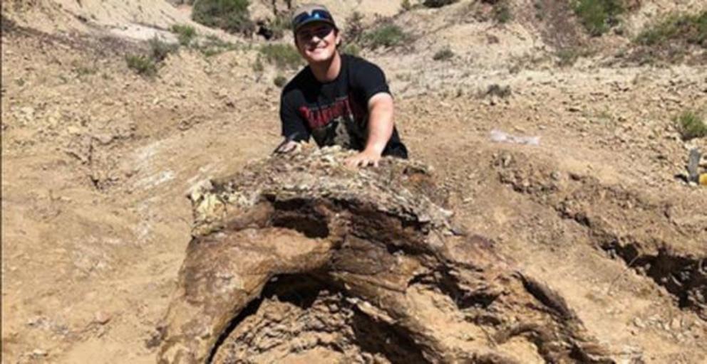 Harrison Duran with the triceratops skull in North Dakota.