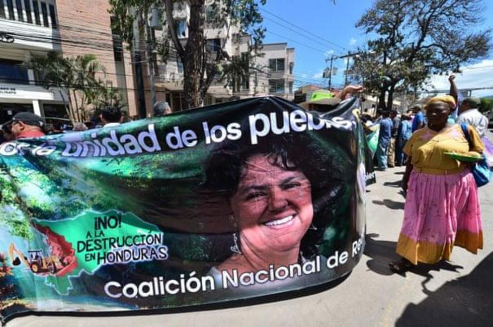 People demonstrate for the liberation of 13 convicted environmentalists with a banner depicting Honduran murdered environmental leader Berta Cáceres as they arrive for a hearing in Tegucigalpa.
