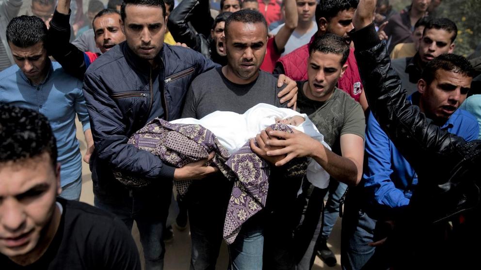 Mourners carry the body of a Palestinian, 14-month-old, Seba Abu Arar, during her funeral in Gaza City, May. 5, 2019. Gaza’s Health Ministry said a Palestinian infant was killed when Israeli aircraft hit near their house. Abu Arar, 14-month-old, died imme