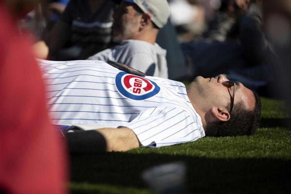 A man relaxes outside Wrigley Field earlier this year. Federal rules don't require cellphones to be positioned against the body when they are tested for radiofrequency radiation. (Erin Hooley / Chicago Tribune)
