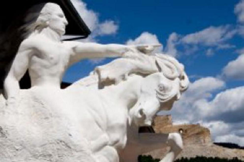 A model of the planned colossal sculpture, with the Crazy Horse Memorial in the background.