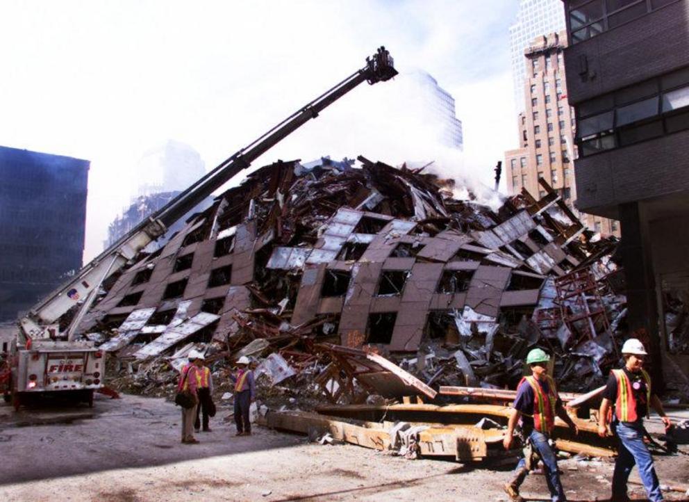 Firefighters hose down the smoldering remains of 7 World Trade Center Tuesday, Sept. 18, 2001, in New York.