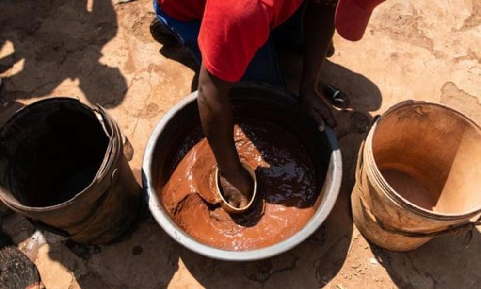 Thabo Dikgang, a zama zama from Carletonville, processes gold outside his home.