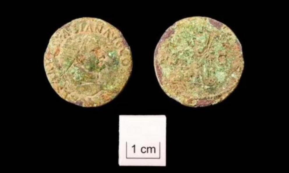 Coins found at the Roman slave burial site dating back to Emperor Vespasian.